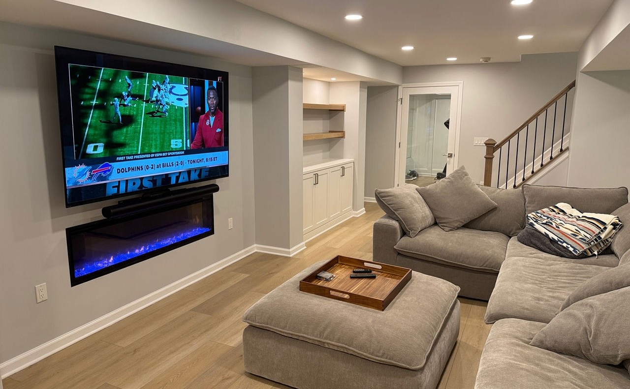 Fairfax Virginia finished basement after remodeling with navy custom bar and lounge seating