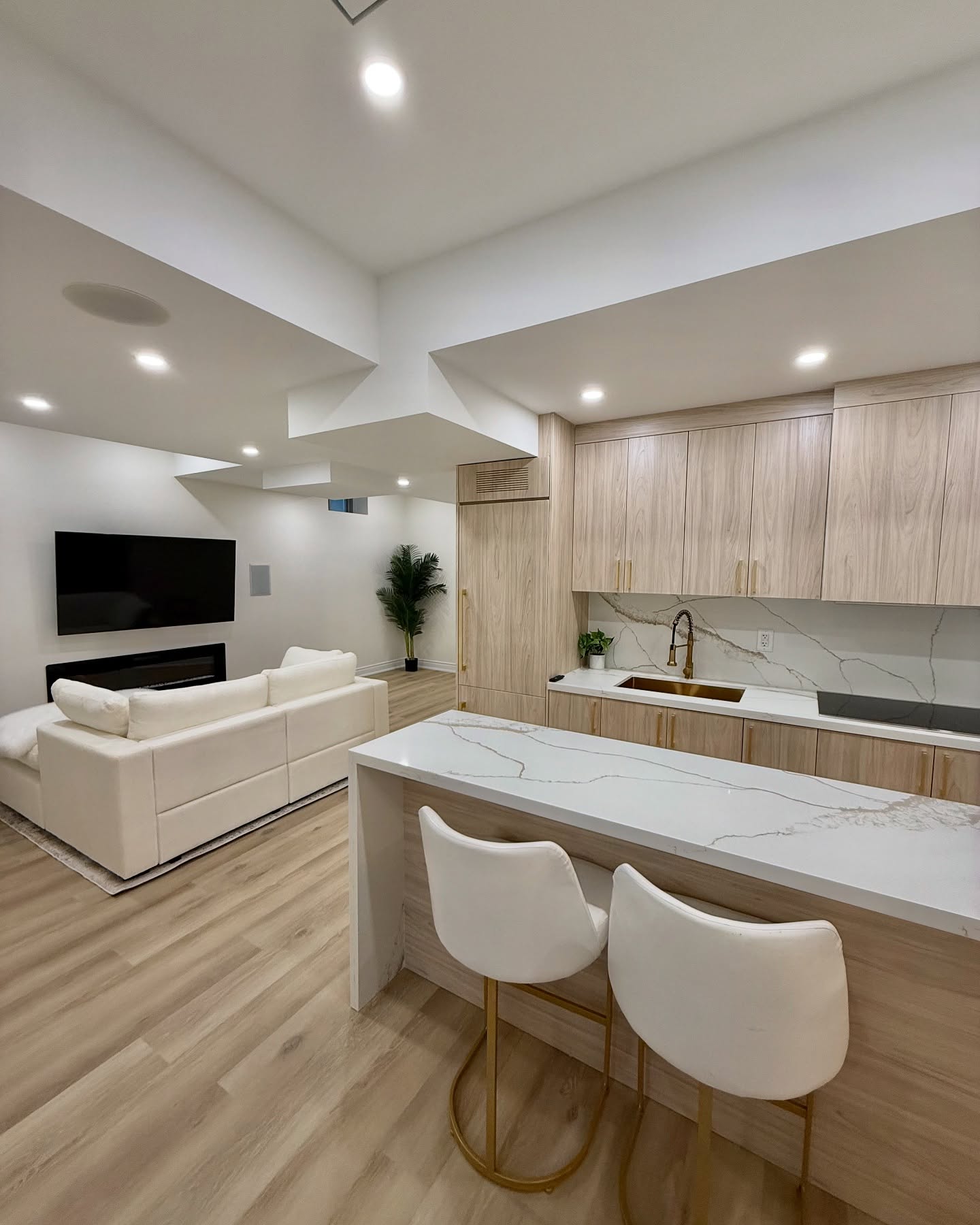 Remodeled living room with built-in shelving and hardwood floors